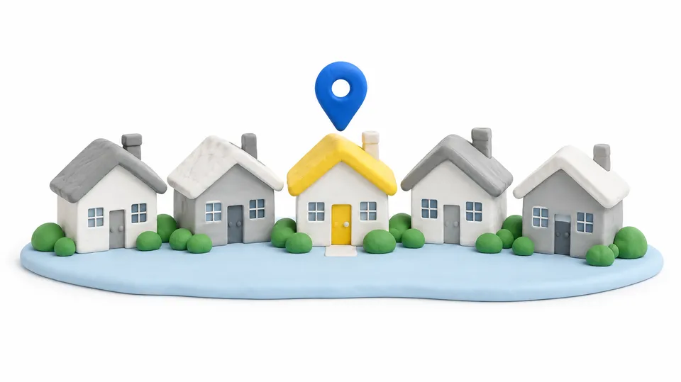 3D-figur i ler-look med små huse på række, hvor ét hus med gult tag er markeret med en blå nål